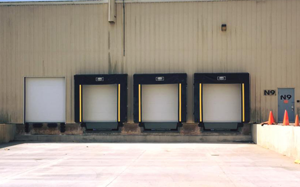 Loading docks with protective bumpers at Kodiak Equipment Services facility.