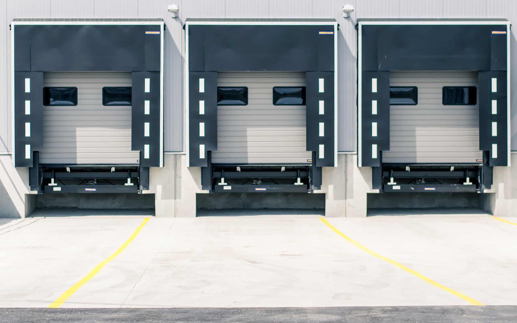 Industrial loading dock doors at Kodiak Equipment Services facility.
