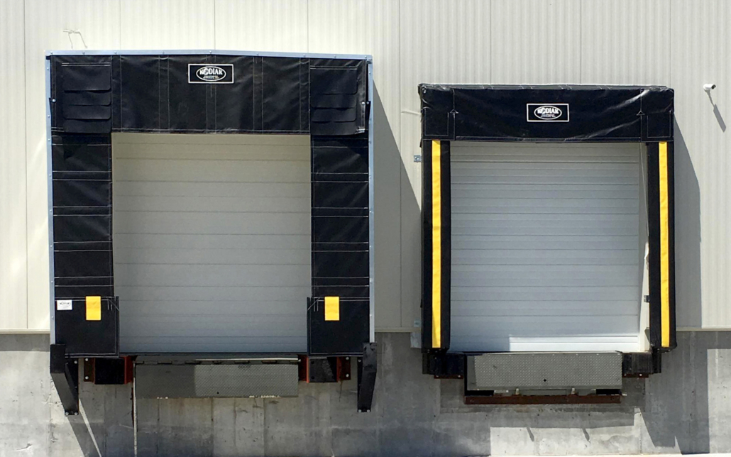 Industrial loading dock shelters and roll-up doors at Kodiak Equipment Services facility.