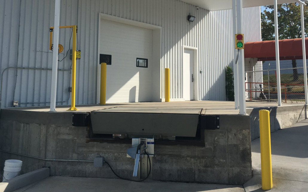 Loading dock with safety barriers and equipment at Kodiak Equipment Services.