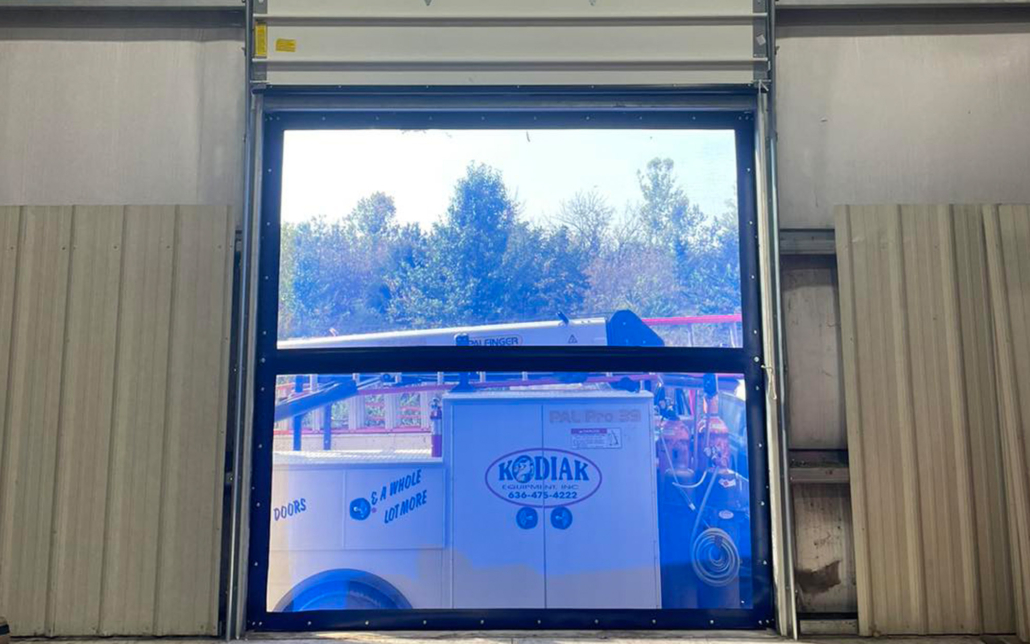 Commercial garage door opening to equipment storage area.