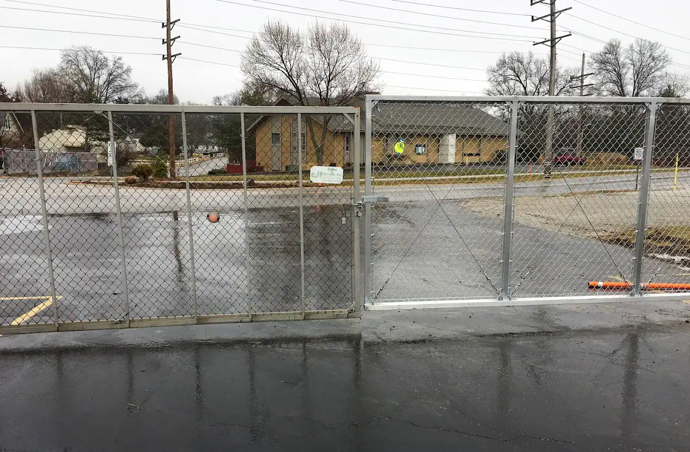 Secure chain-link gate with a lock, part of commercial property fencing in St Louis.