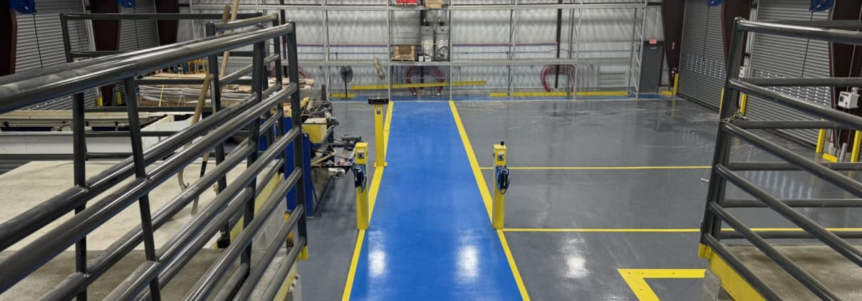 Heavy-duty overhead crane in industrial facility with safety markings.